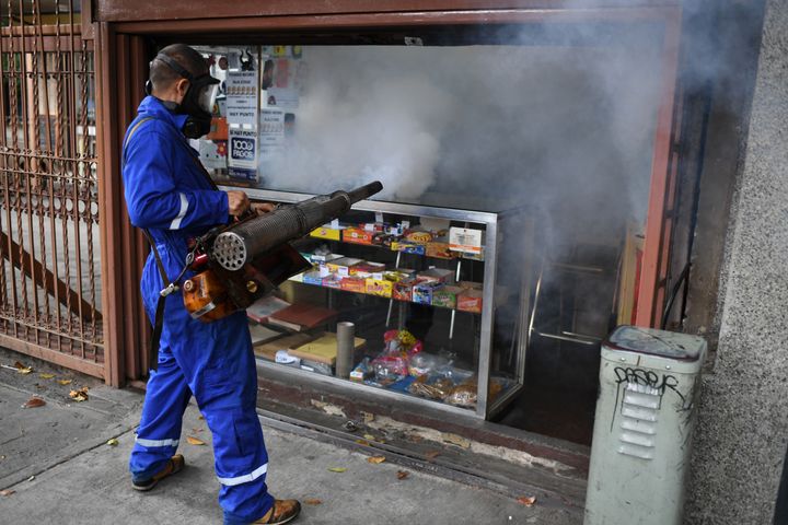 A municipal worker fumigates a store against the aedes aegypti mosquito, vector of dengue fever, Zika fever and chikunguya, i